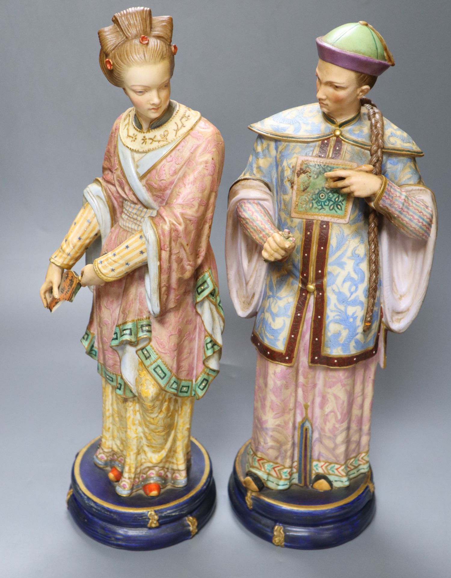 A pair of 19th century coloured bisque porcelain Oriental figures, height 38cm